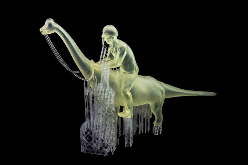 A 3D printed translucent figurine of a person riding a dinosaur.