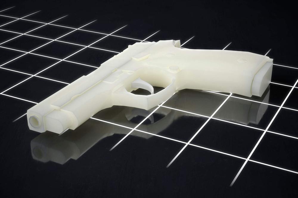 A white handgun lies on a black reflective surface with a grid pattern.