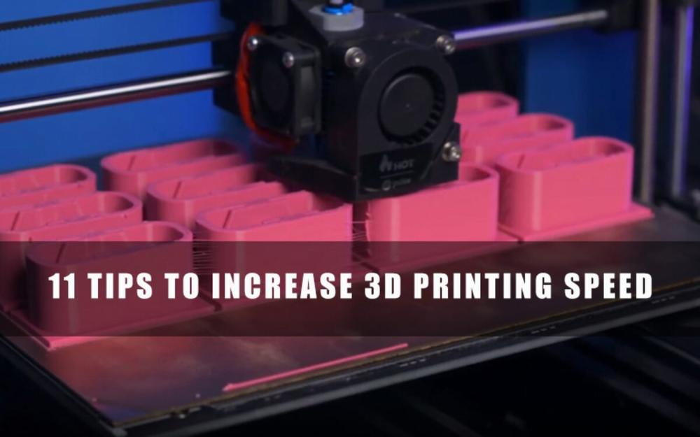 3D printer depositing layers of pink plastic to create multiple small objects simultaneously.