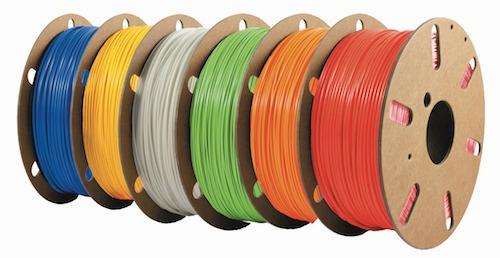 Five spools of colored 3D printer filament.