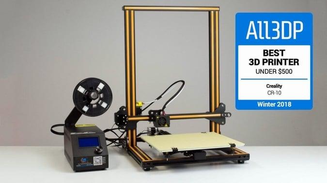 The image shows a black and yellow Creality CR-10 3D printer with a spool of filament on top.