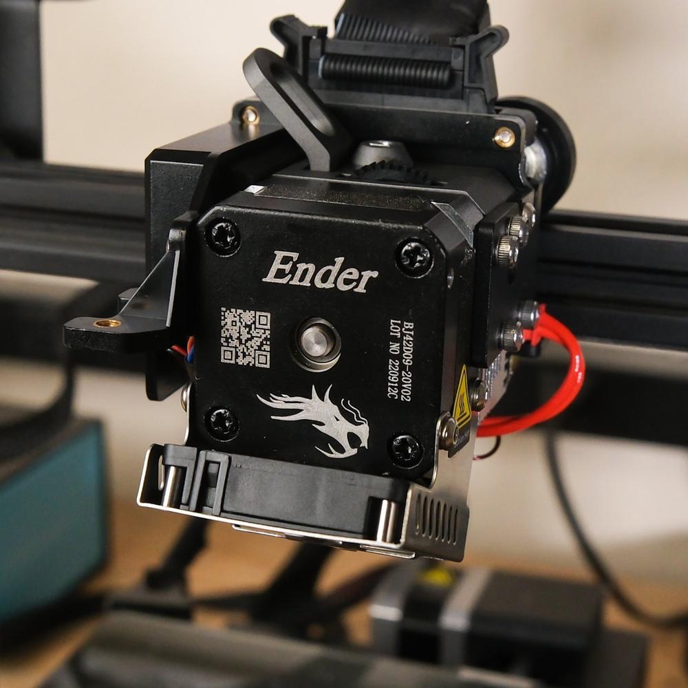 Close-up of the black metal extruder of an Ender 3 V2 3D printer.