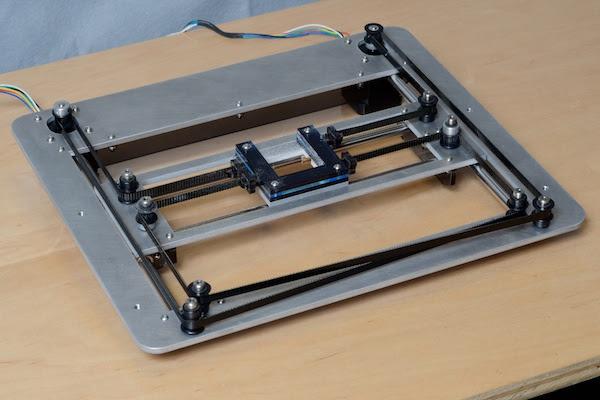 An image of a CoreXY 3D printer with a moving print bed.