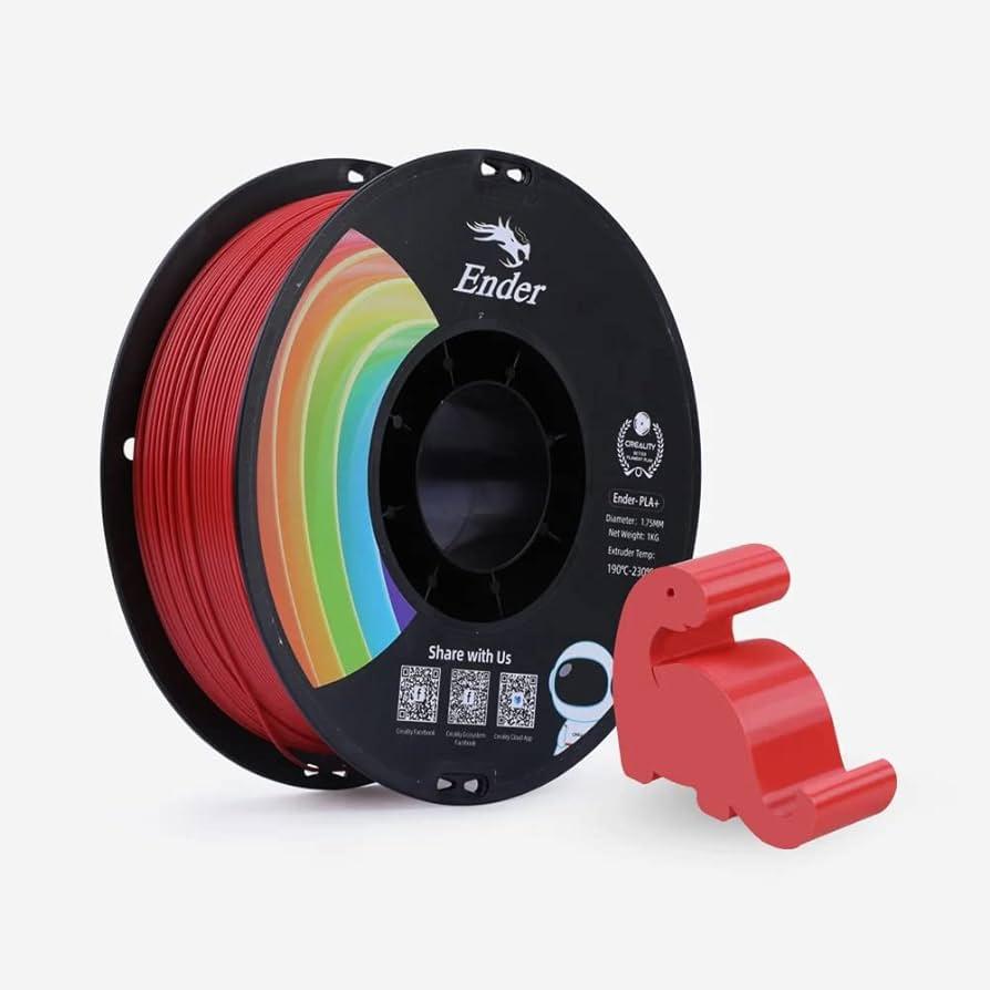 A red spool of Ender PLA+ 3D printer filament, with a small red 3D printed dinosaur next to it.