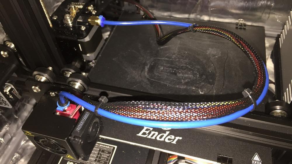 A blue Capricorn Bowden tube is installed on an Ender 3 3D printer.