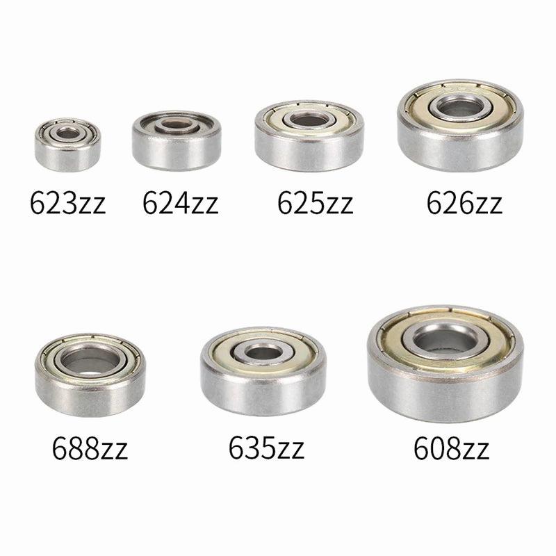 A set of seven different-sized metal ball bearings.