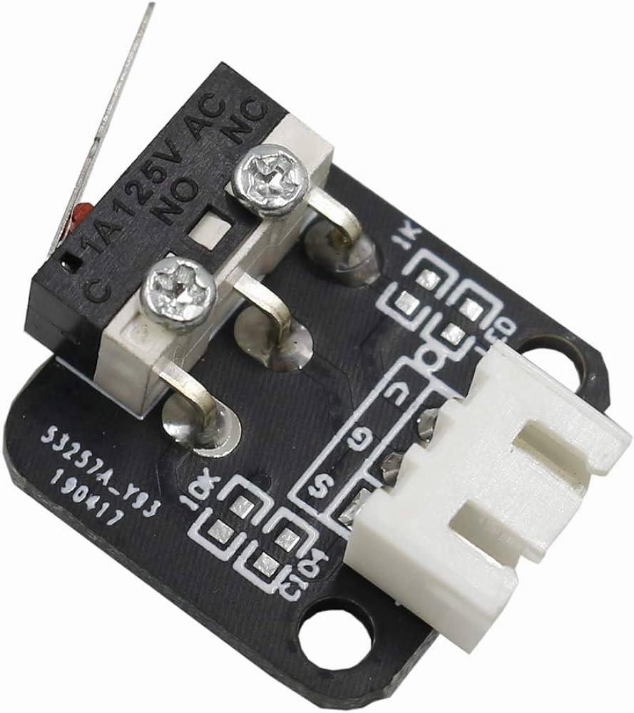A small black printed circuit board with a red button switch and a white connector.