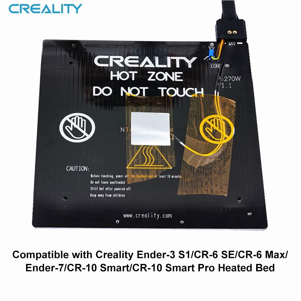 A black Creality magnetic heated bed with a yellow thermistor wire.