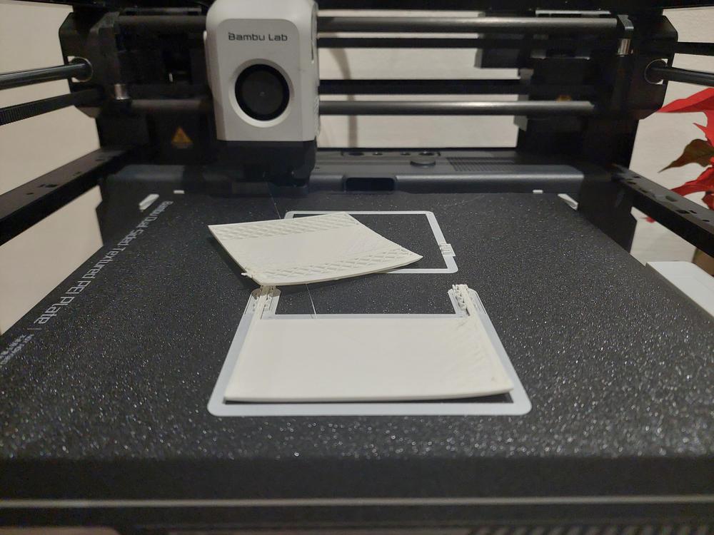A 3D printer is printing a white object.