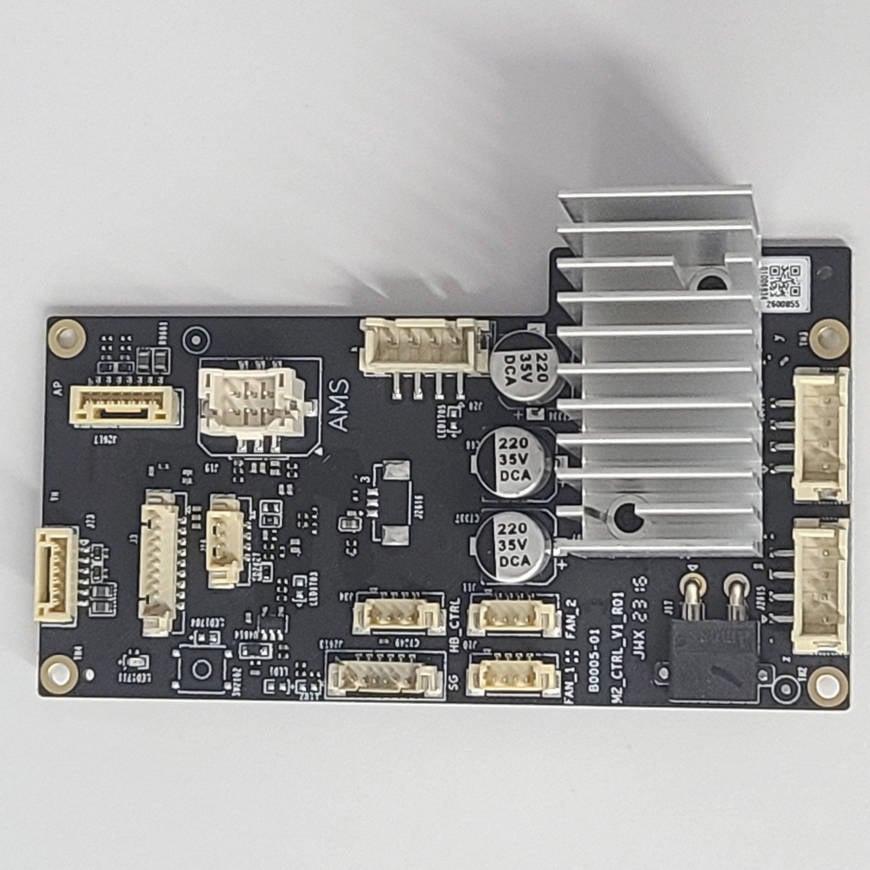 An image of a black PCB with surface-mounted components, including a large heat sink.