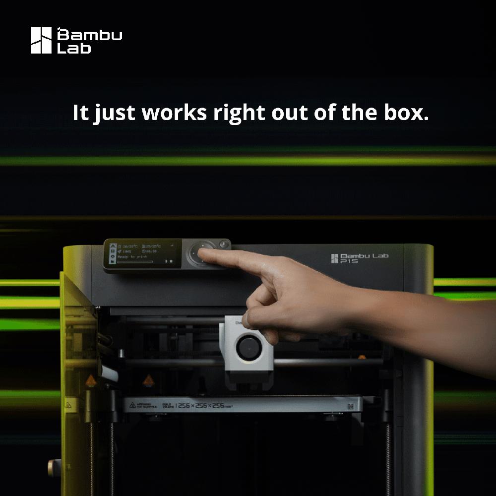 A finger presses the touchscreen of a black 3D printer with a green light.