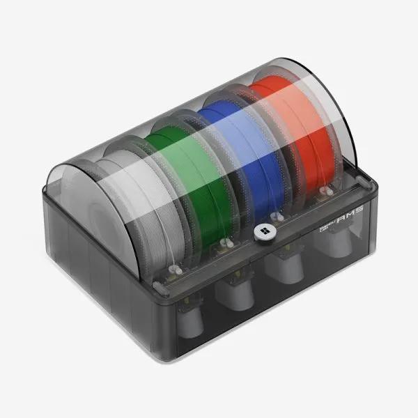 A black and gray filament storage box with a clear lid containing five spools of different colored filament.