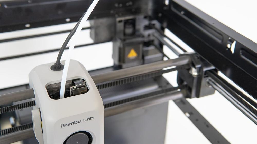 Close-up of the filament sensor on a Bambu Lab X1 Carbon 3D printer.