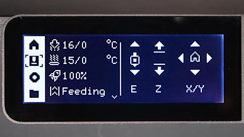 The image is of a small black display with blue text that displays information about a 3D printers temperature and other settings.