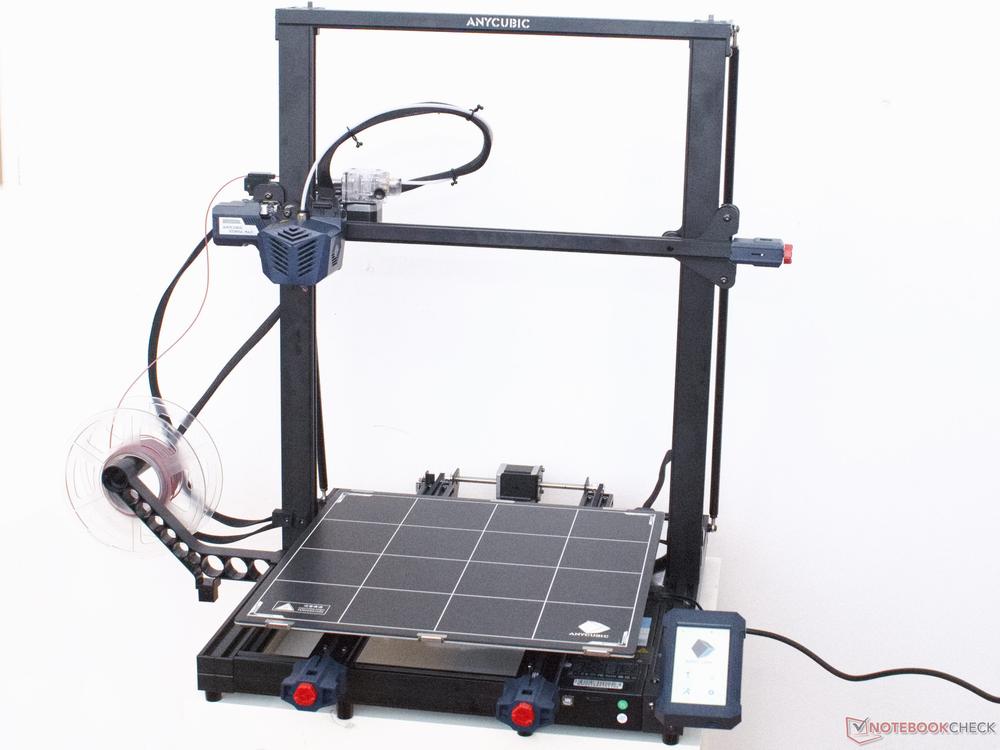 The image shows an Anycubic 3D printer with a blue frame and a black print bed.