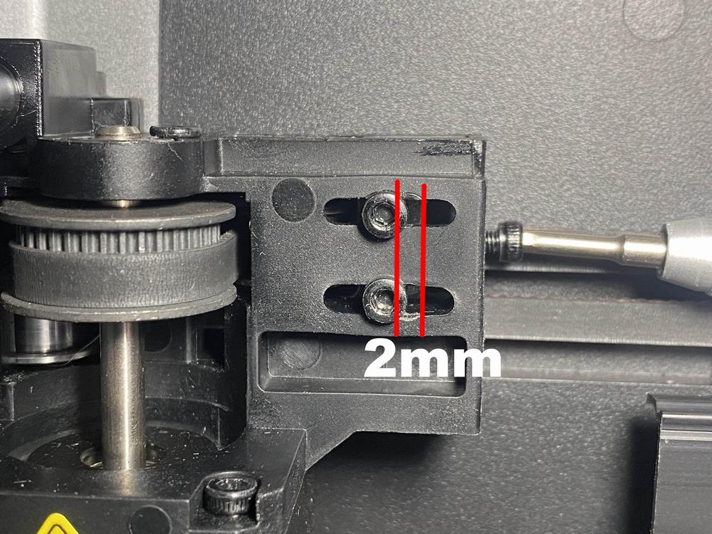 Image shows two screws that are 2mm apart on a black 3D printer part.