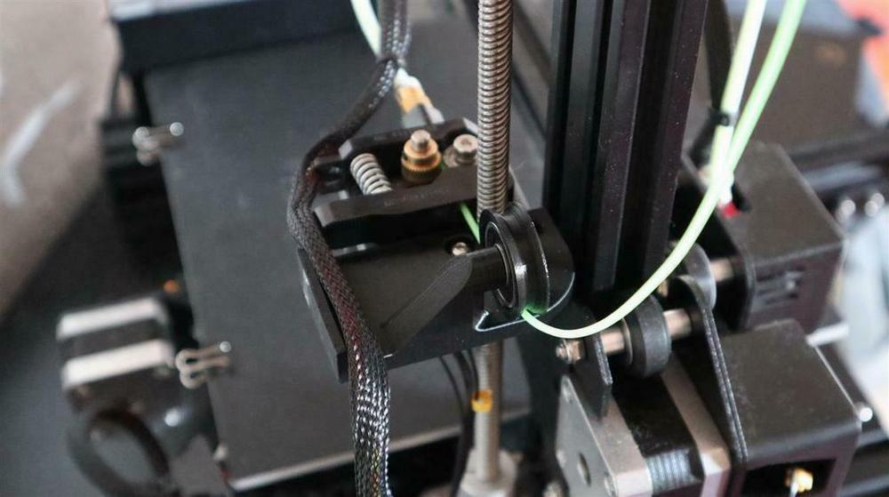 Close-up of the filament extruder on a 3D printer.
