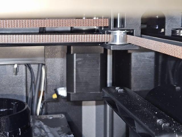 A 3D printer prints a brown object.