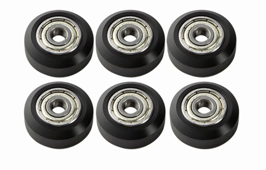 Six black plastic wheels with a metal ball bearing in the center.