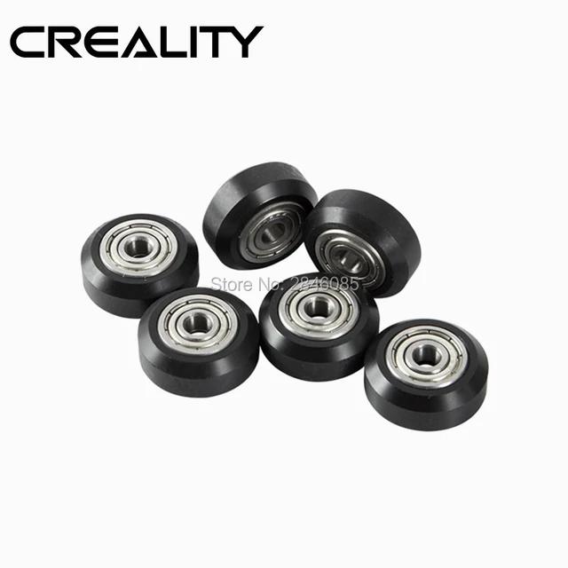 Six black plastic wheels with bearings, likely for use in a 3D printer.