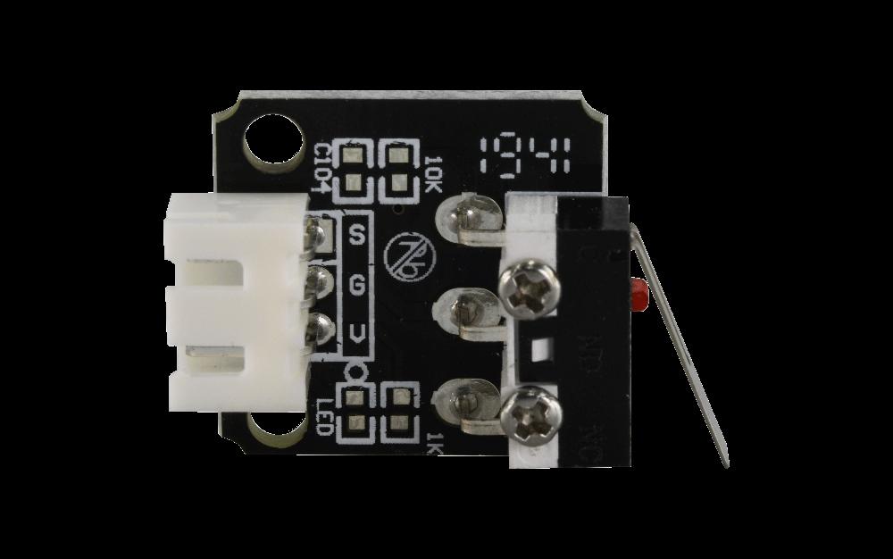 A small black PCB with a red lever switch and a white connector.