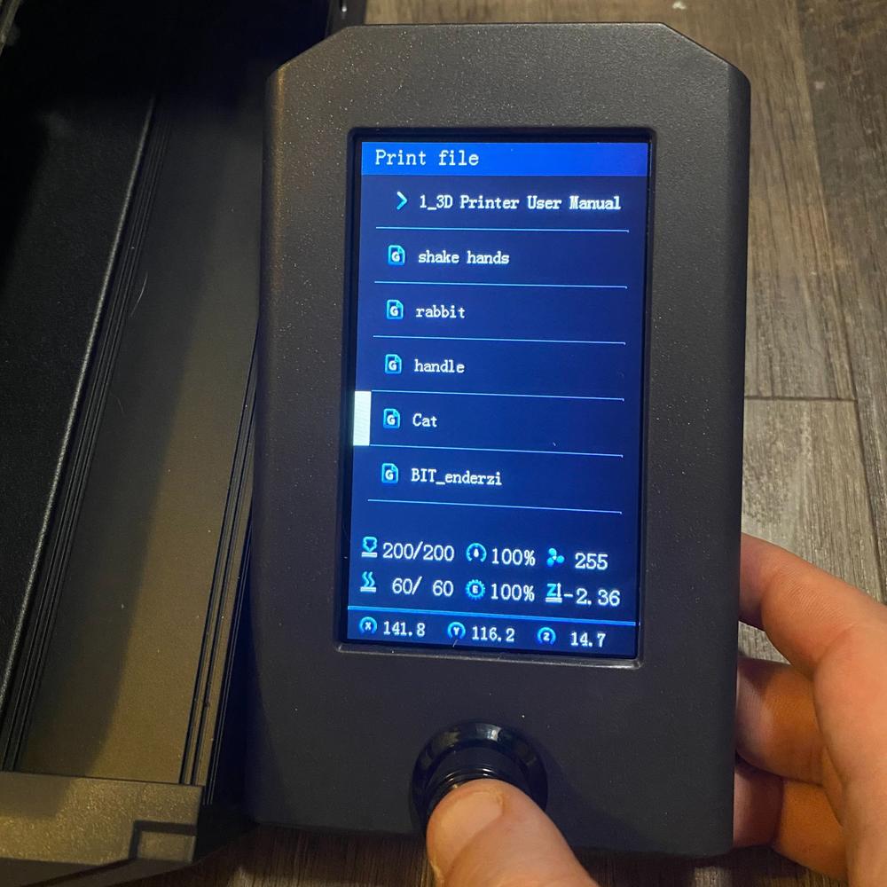 A photo of a 3D printers touchscreen display, showing the print file options.