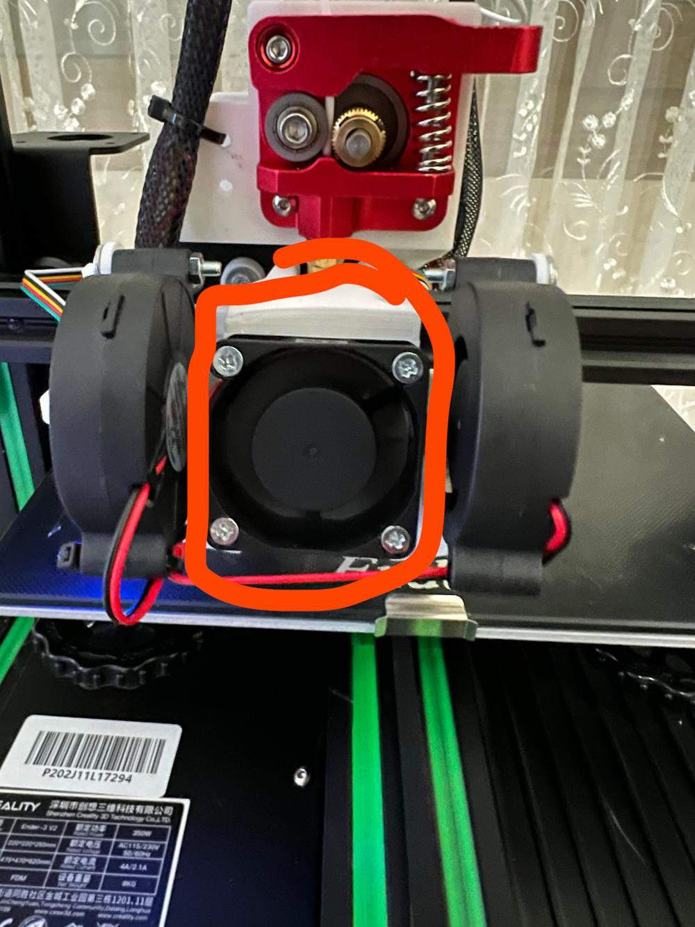 The image shows a close-up of a black fan on a 3D printer.