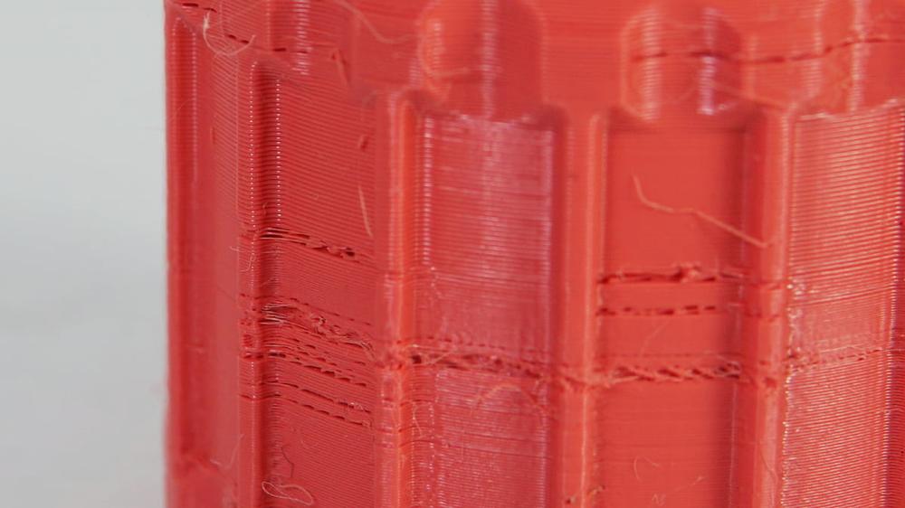Close-up of a 3D printed object with visible layer lines.