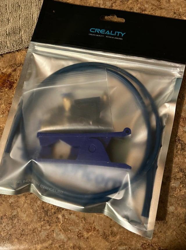 A blue Capricorn Bowden tube and coupler in a plastic bag.
