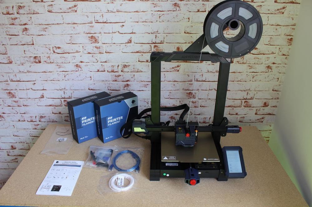 The image shows an unboxing of an Anycubic Mega X 3D printer.