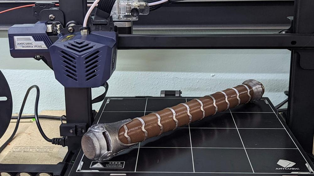 3D printed Mjölnir, Thors hammer, laying on a 3D printers print bed.