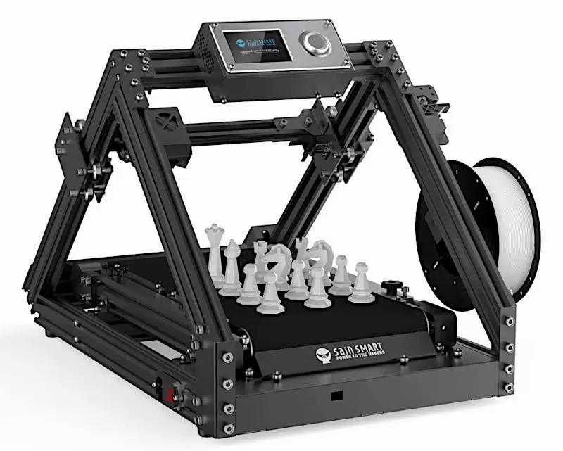 Black and gray 3D printer with a chess set on the print bed.