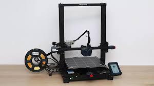 An image of an Artillery Sidewinder X1 3D printer with a spool of yellow filament.